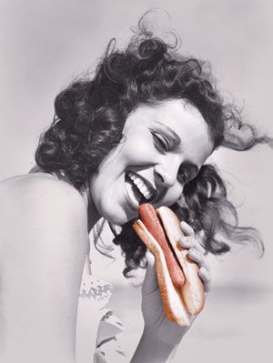 Woman eating Hotdog